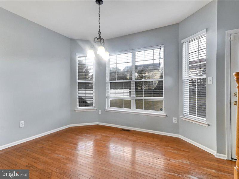 77 Cayuga Road Bordentown, NJ 08505 - Photo 12 of 37 a view of an empty room with wooden floor and a window