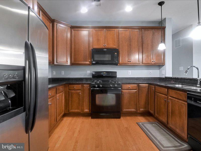 77 Cayuga Road Bordentown, NJ 08505 - Photo 14 of 37 a kitchen with stainless steel appliances granite countertop a stove a sink and a microwave