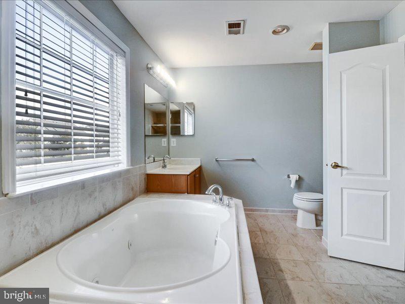 77 Cayuga Road Bordentown, NJ 08505 - Photo 24 of 37 a bathroom with a toilet sink and mirror