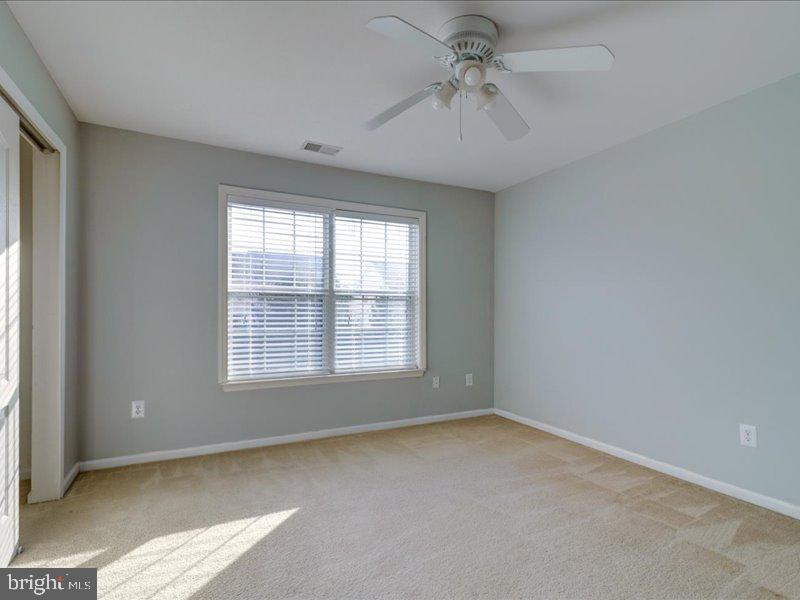 77 Cayuga Road Bordentown, NJ 08505 - Photo 27 of 37 an empty room with a window and a fan