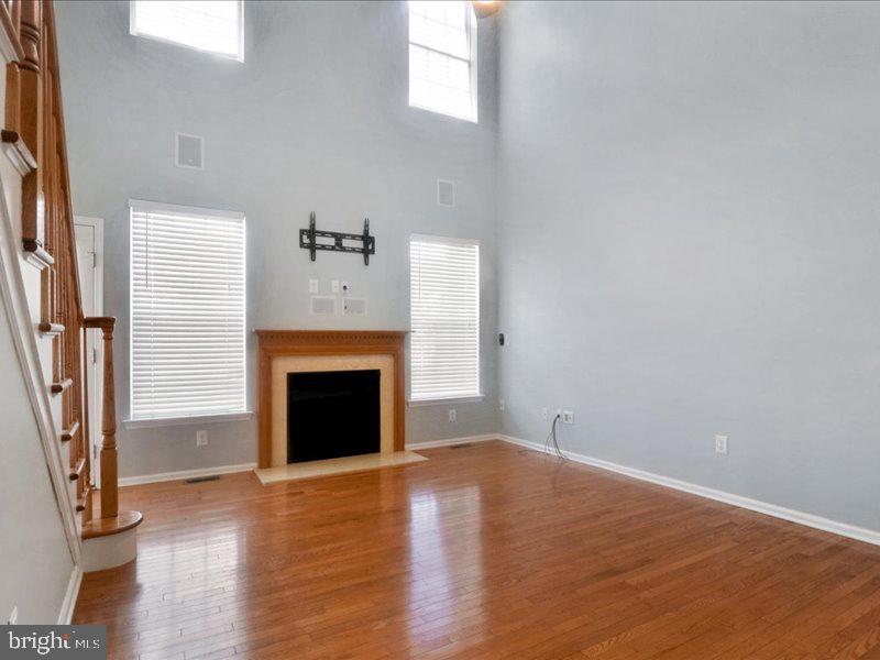 77 Cayuga Road Bordentown, NJ 08505 - Photo 9 of 37 an empty room with wooden floor and a fireplace