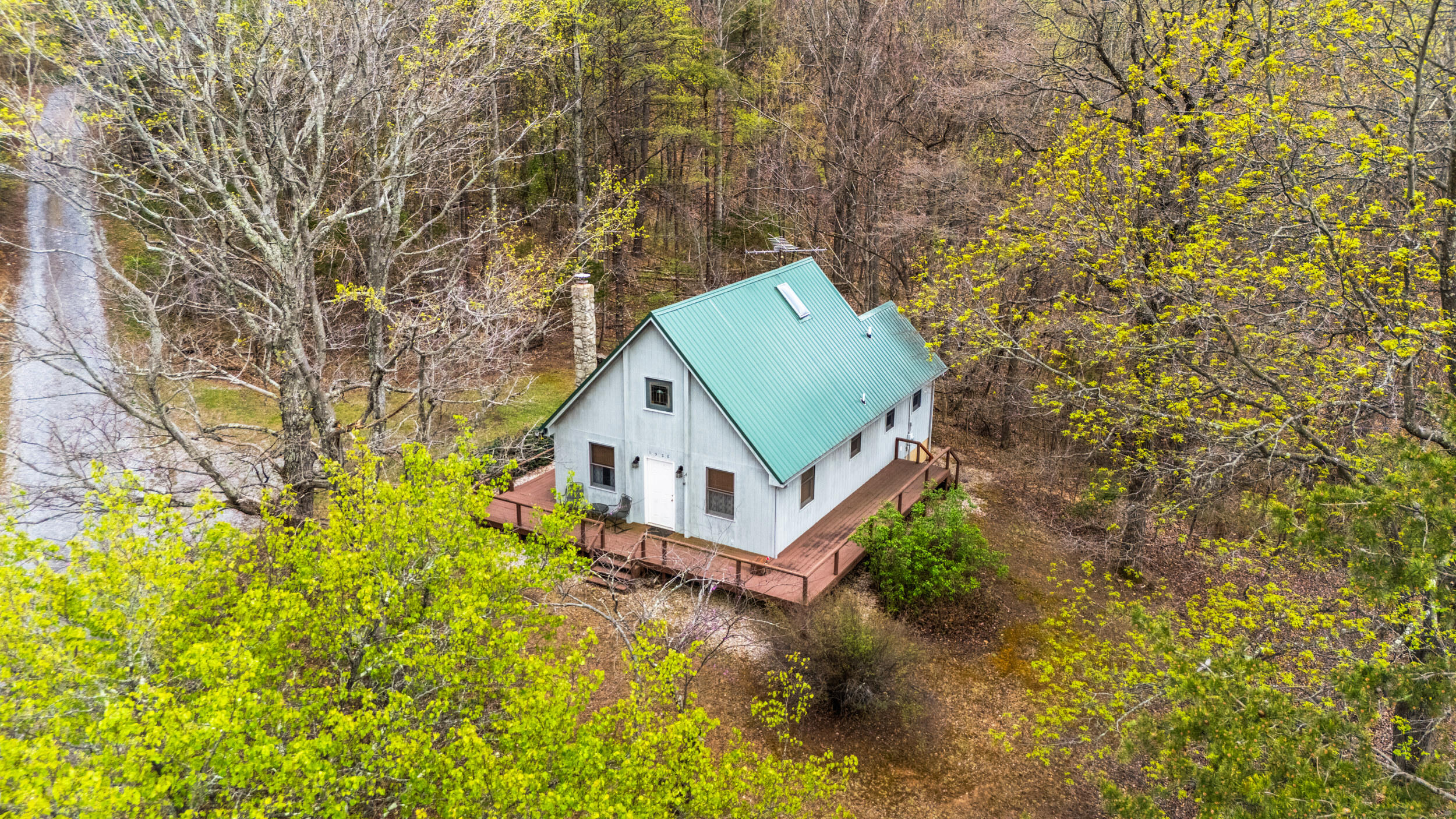 1374 Moccasin Road Thaxton, VA 24174 - Photo 49 of 81 a view of a house with a small yard and large trees