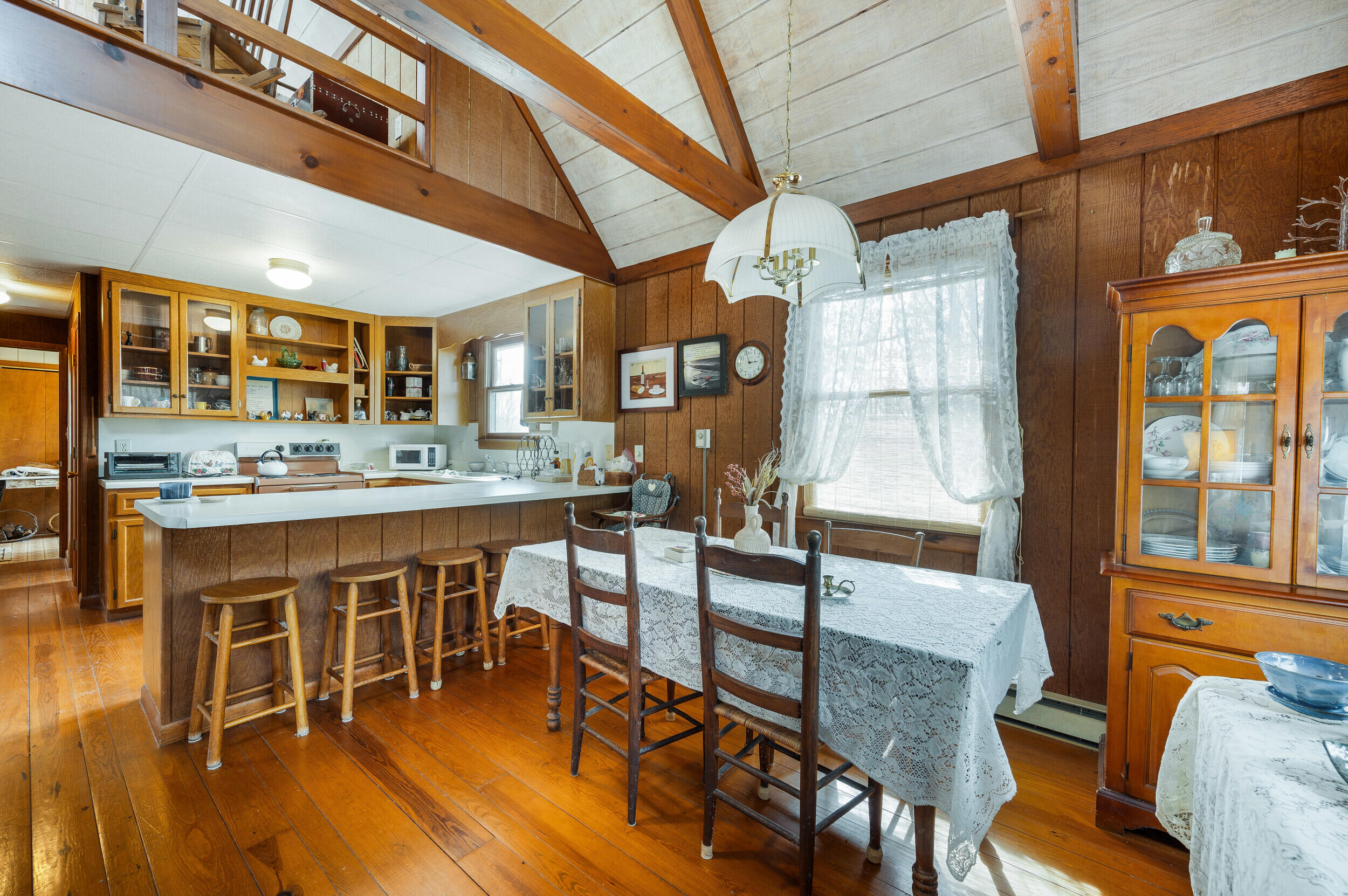 1374 Moccasin Road Thaxton, VA 24174 - Photo 54 of 81 a dining room with stainless steel appliances a dining table and chairs with wooden floor