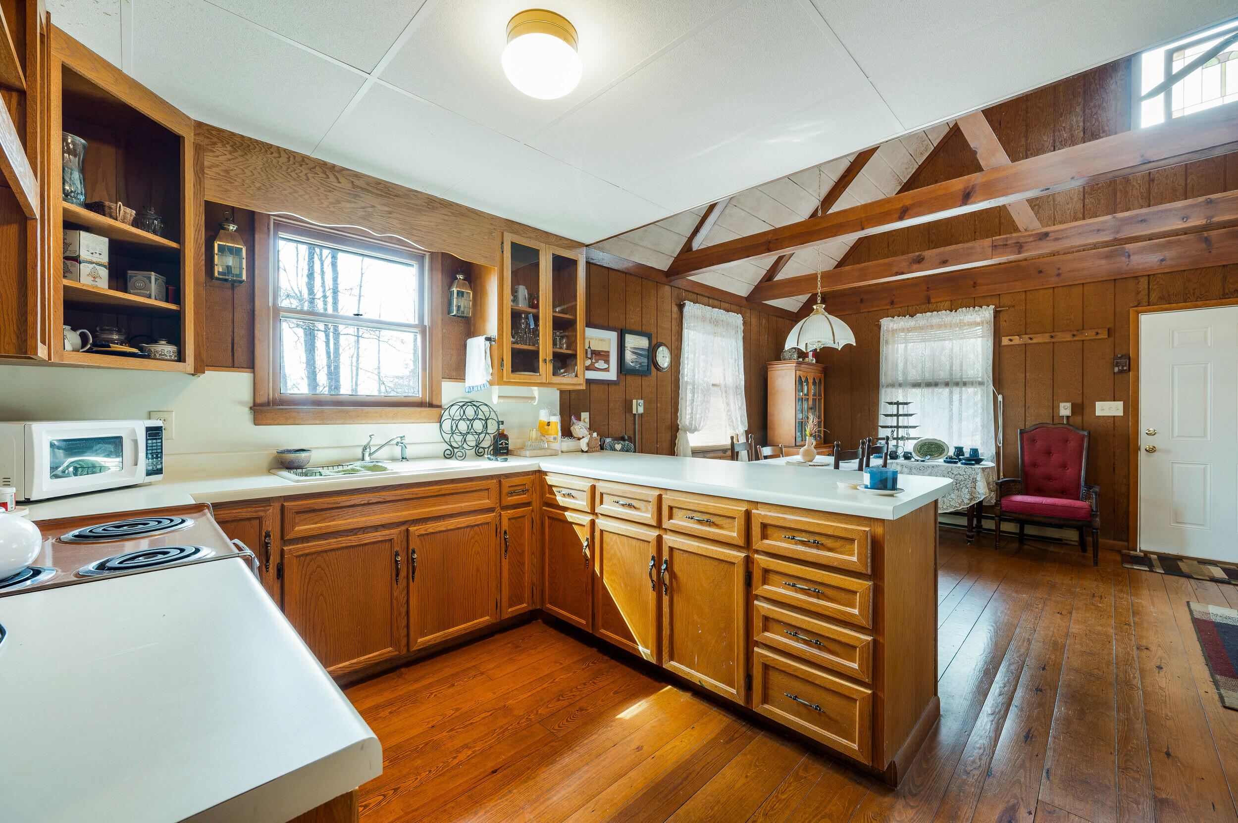 1374 Moccasin Road Thaxton, VA 24174 - Photo 56 of 81 a kitchen with a sink and wooden cabinets