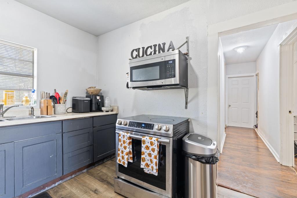 301 South Morrow Street Blue Ridge, TX 75424 - Photo 13 of 30 a kitchen with a stove and a microwave