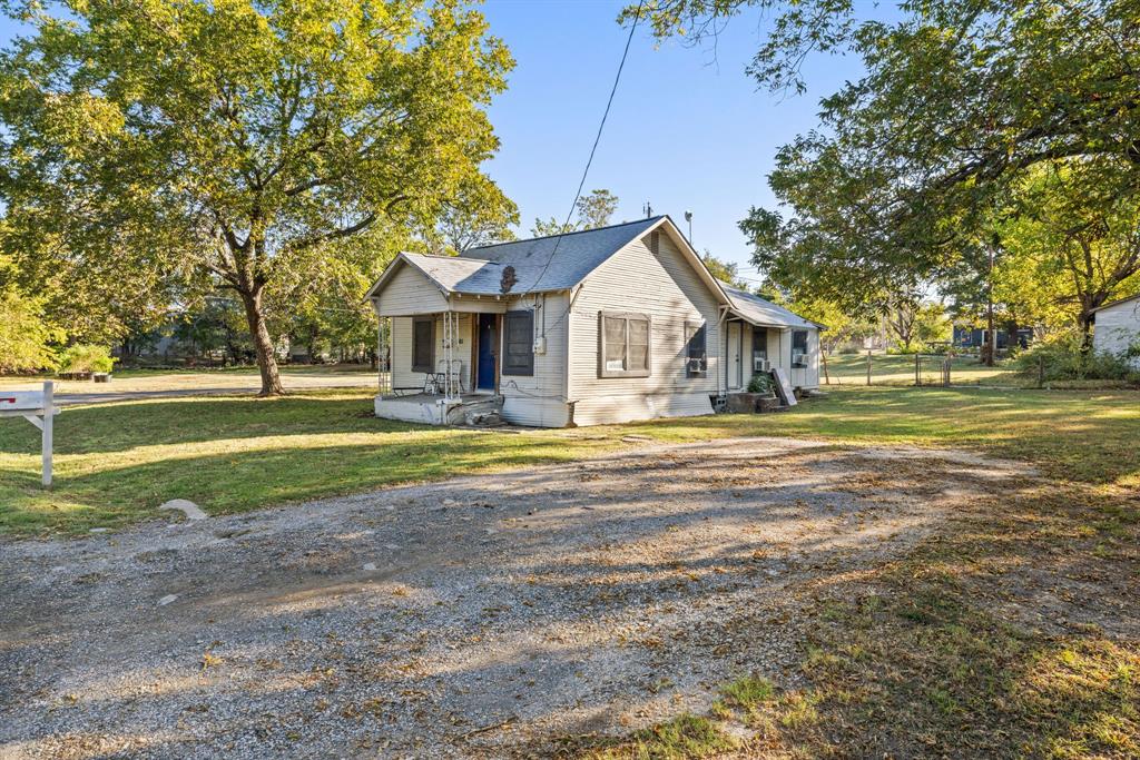 301 South Morrow Street Blue Ridge, TX 75424 - Photo 3 of 30 a front view of a house with a yard and trees