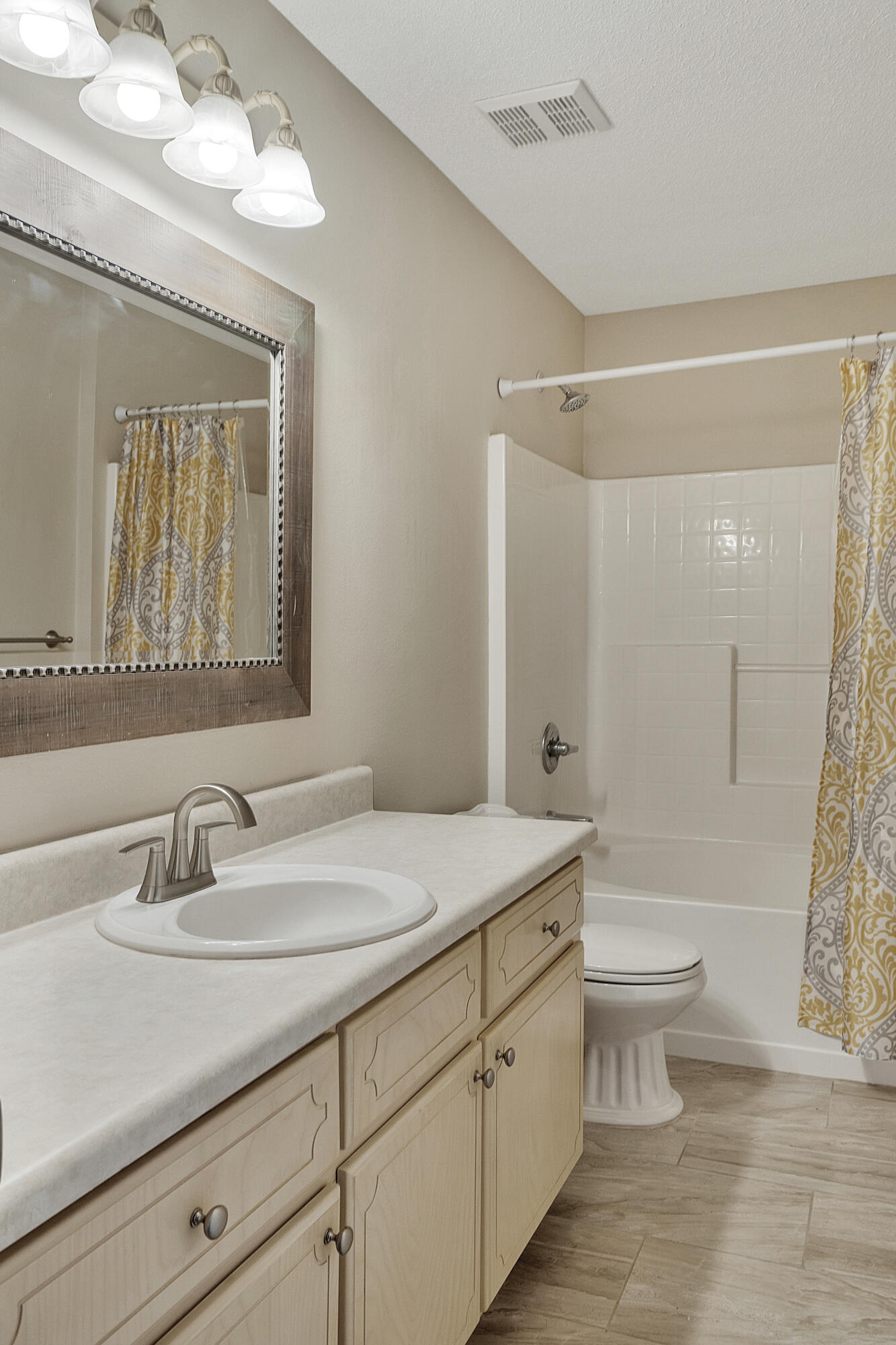 5360 Walker Road Milton, FL 32570 - Photo 14 of 17 a bathroom with a sink a toilet and a large mirror