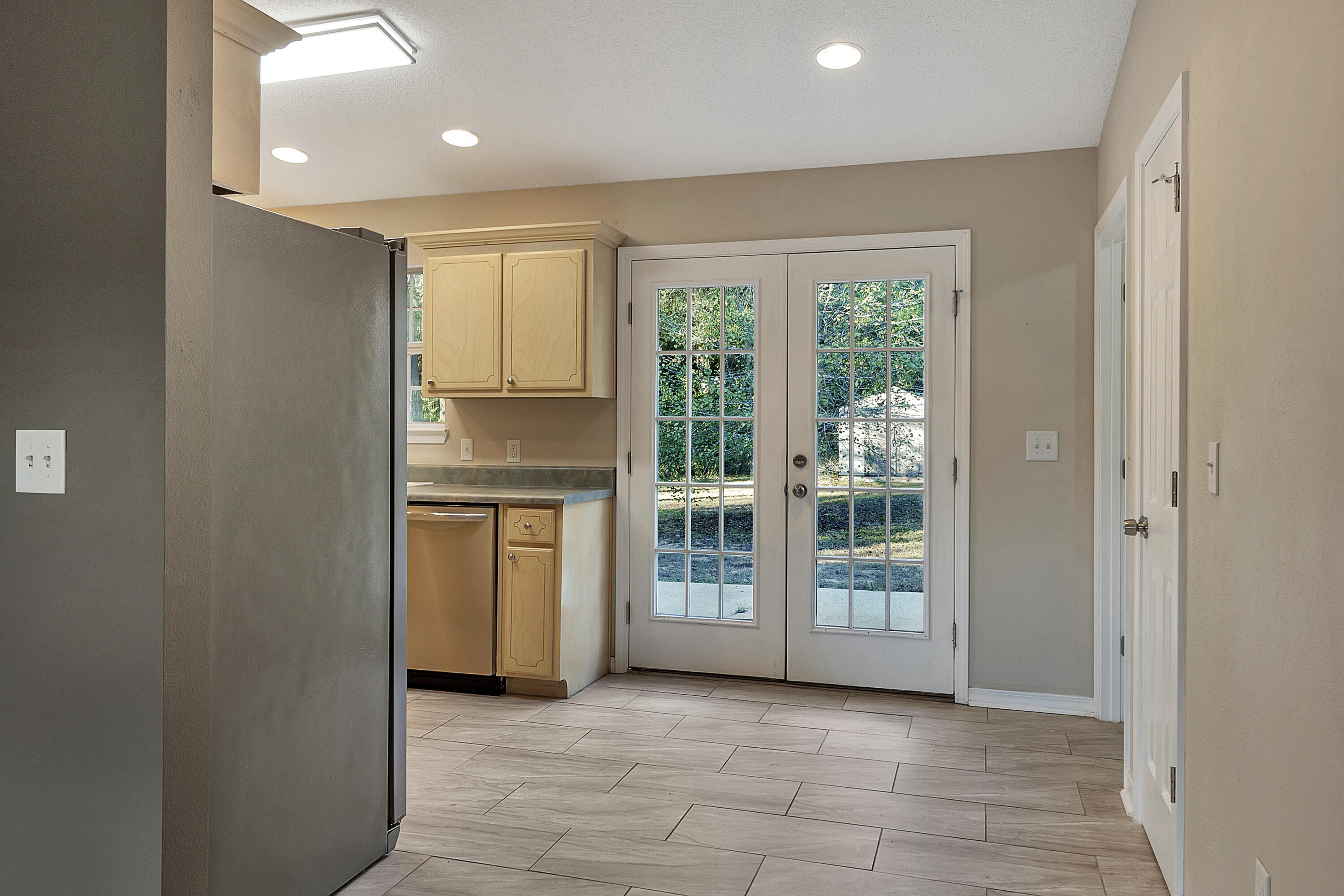 5360 Walker Road Milton, FL 32570 - Photo 4 of 17 a view of an empty room with kitchen and a window