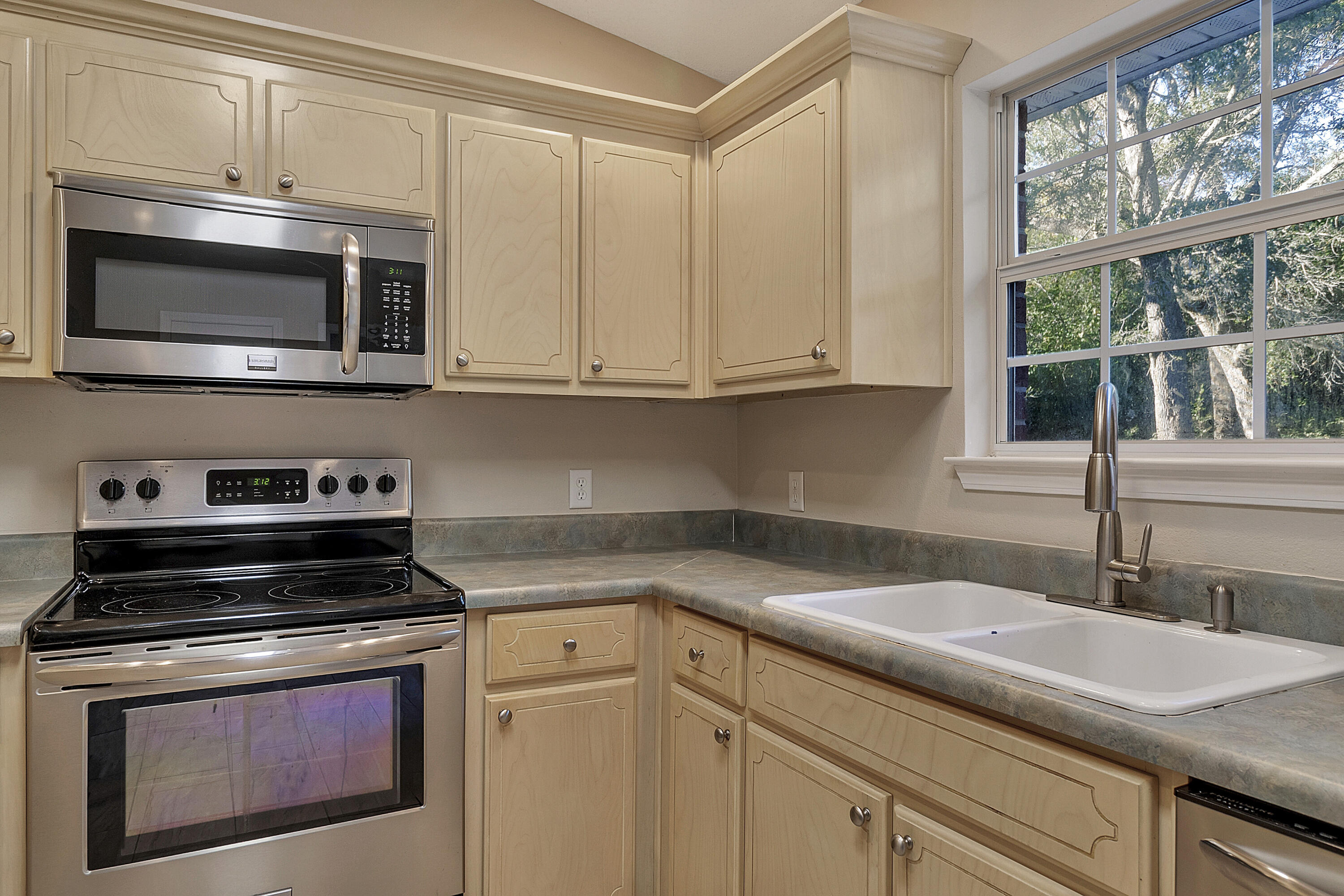 5360 Walker Road Milton, FL 32570 - Photo 7 of 17 a kitchen with appliances a sink and cabinets