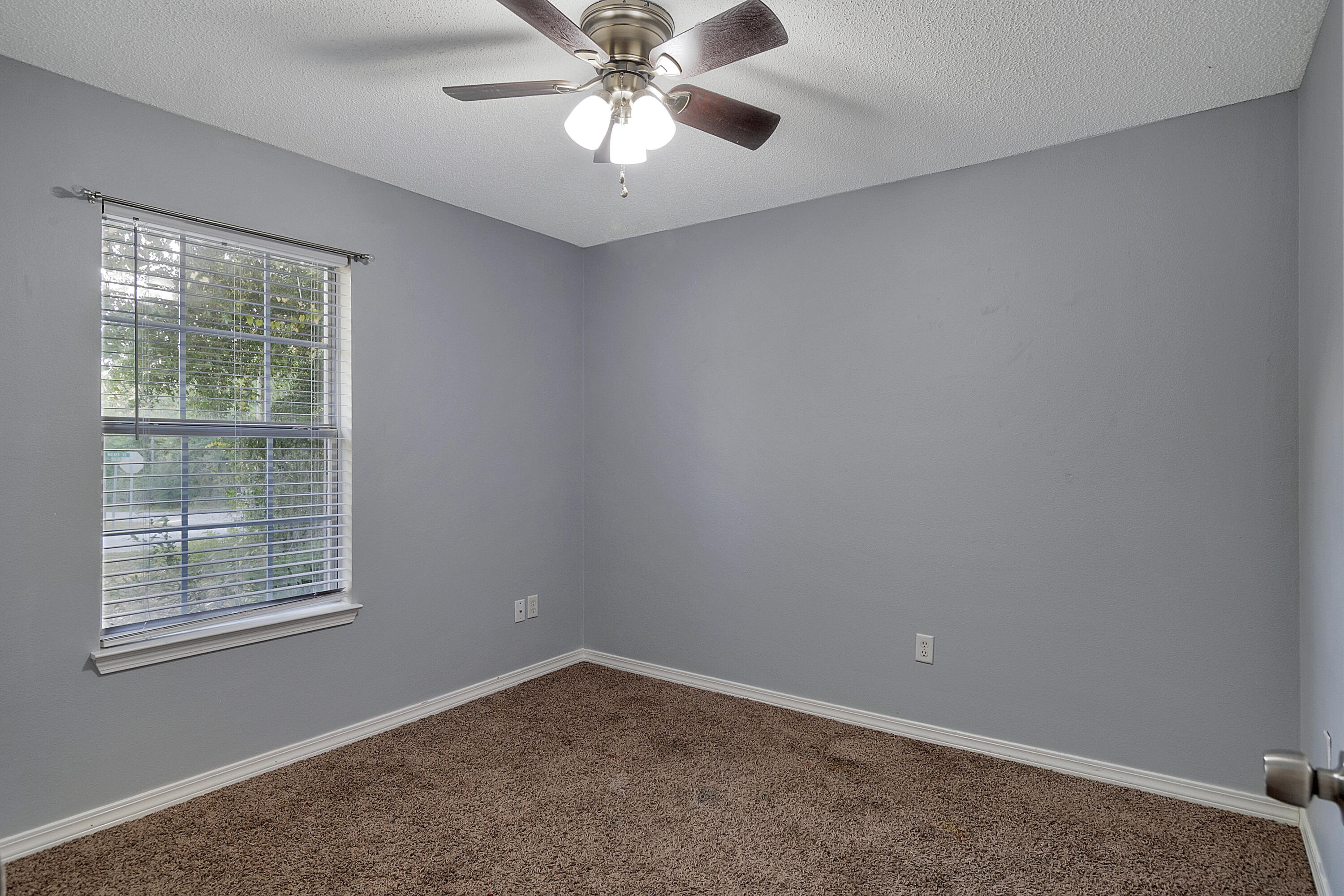 5360 Walker Road Milton, FL 32570 - Photo 9 of 17 an empty room with a window and a fan