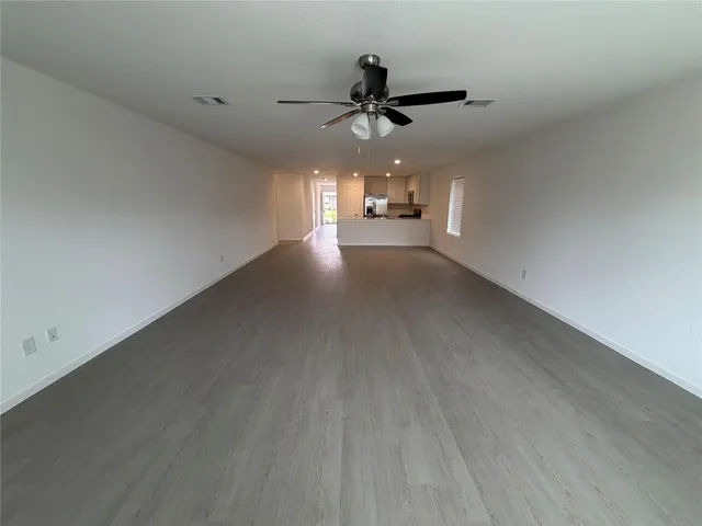 a view of a livingroom with a ceiling fan and window