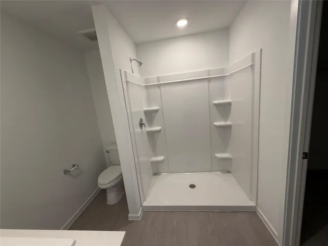 a bathroom with a shower and a toilet