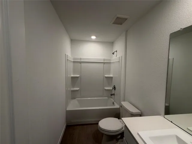 a bathroom with a toilet and a bath tub