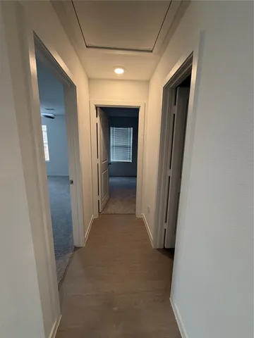 a view of a hallway with wooden shelves