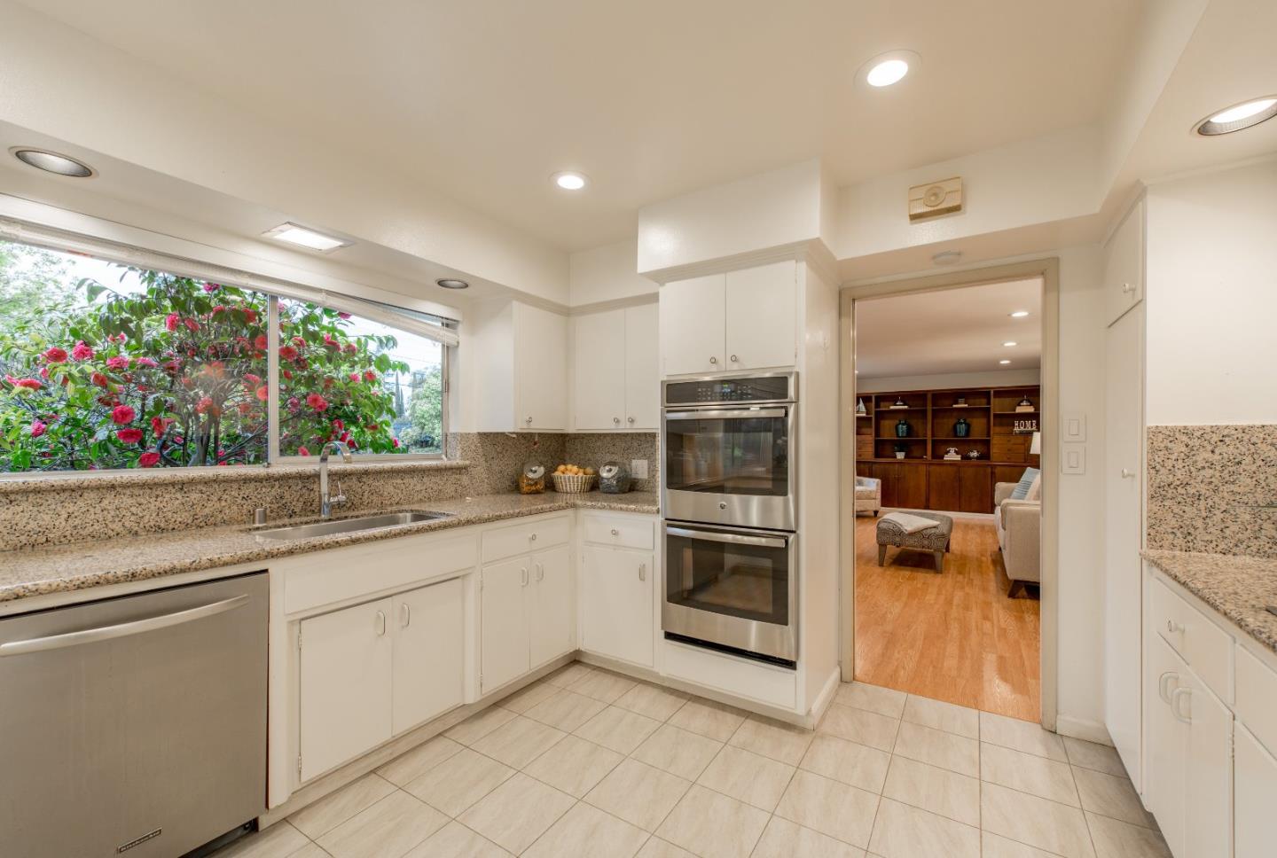 20249 Edinburgh Drive Saratoga, CA 95070 - Photo 12 of 32 a kitchen with white cabinets and appliances