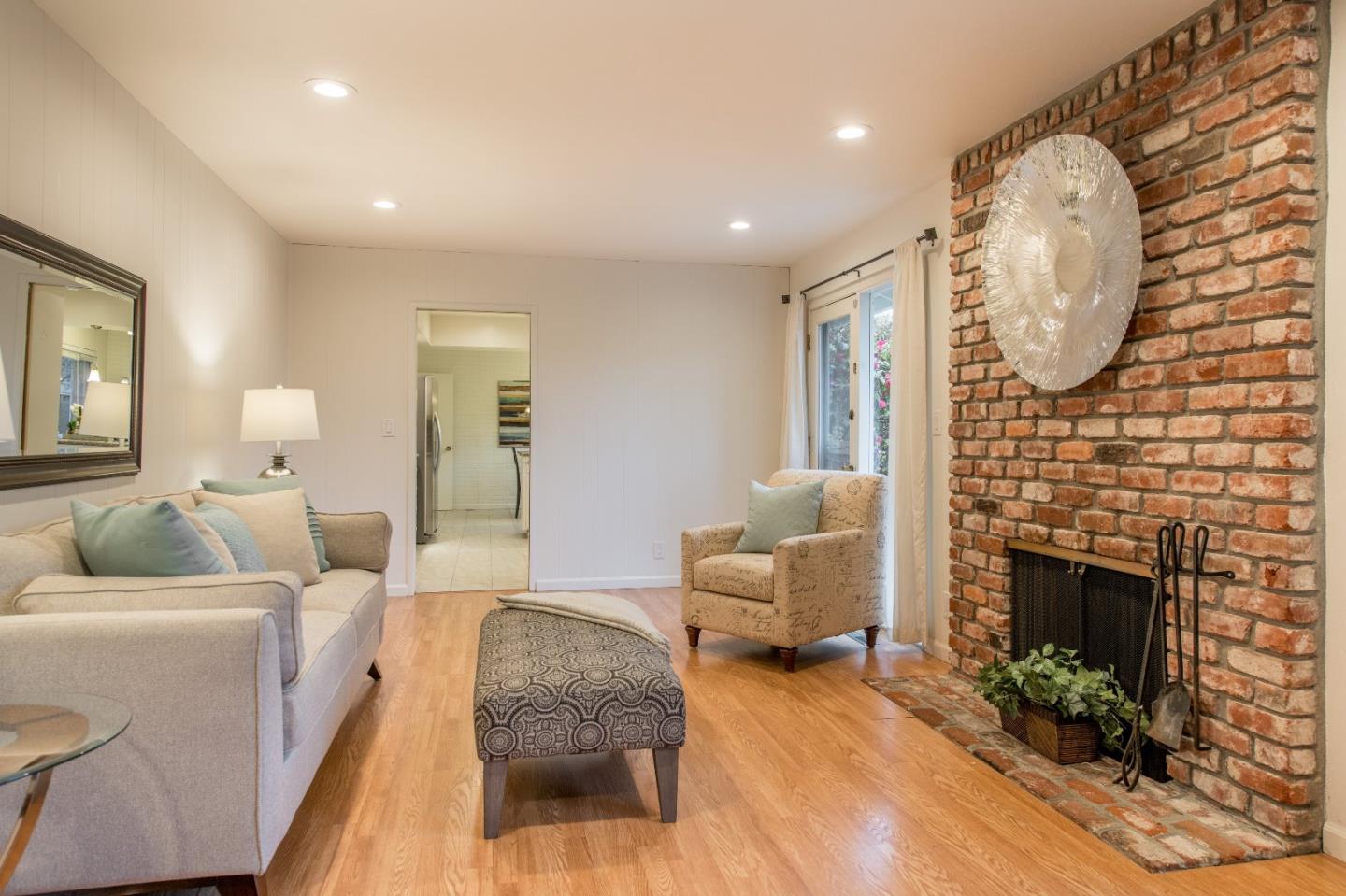 20249 Edinburgh Drive Saratoga, CA 95070 - Photo 15 of 32 a living room with furniture large window and a fireplace