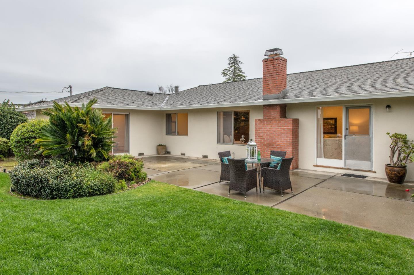 20249 Edinburgh Drive Saratoga, CA 95070 - Photo 23 of 32 a backyard of a house with table and chairs
