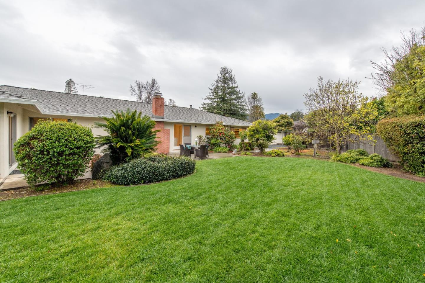 20249 Edinburgh Drive Saratoga, CA 95070 - Photo 27 of 32 a front view of a house with a yard and potted plants