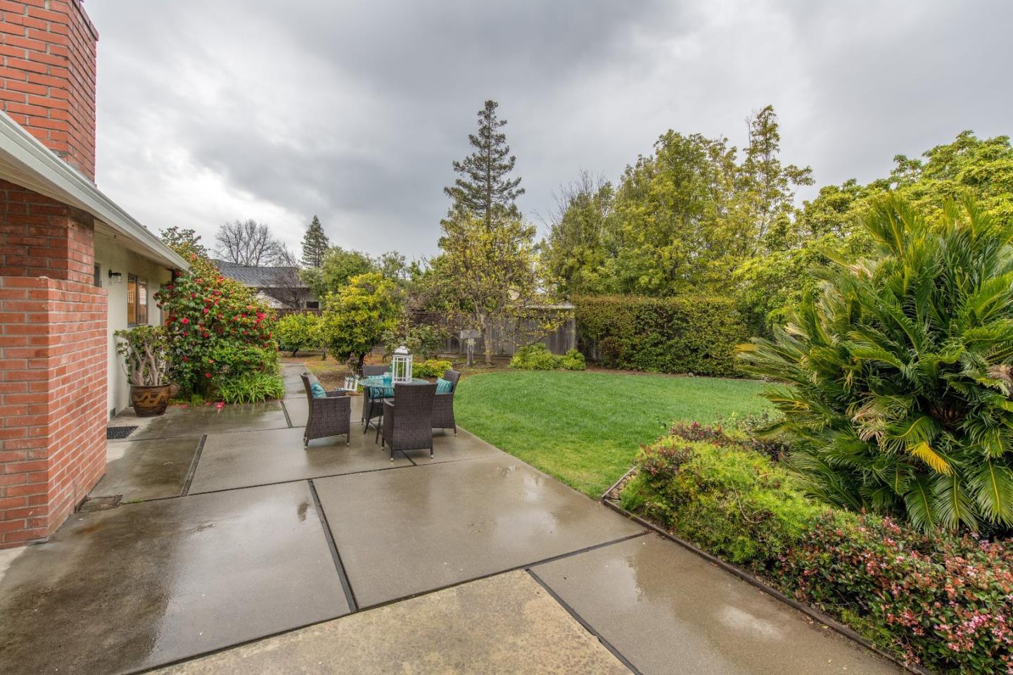 20249 Edinburgh Drive Saratoga, CA 95070 - Photo 30 of 32 a view of a patio with a table and chairs and potted plants