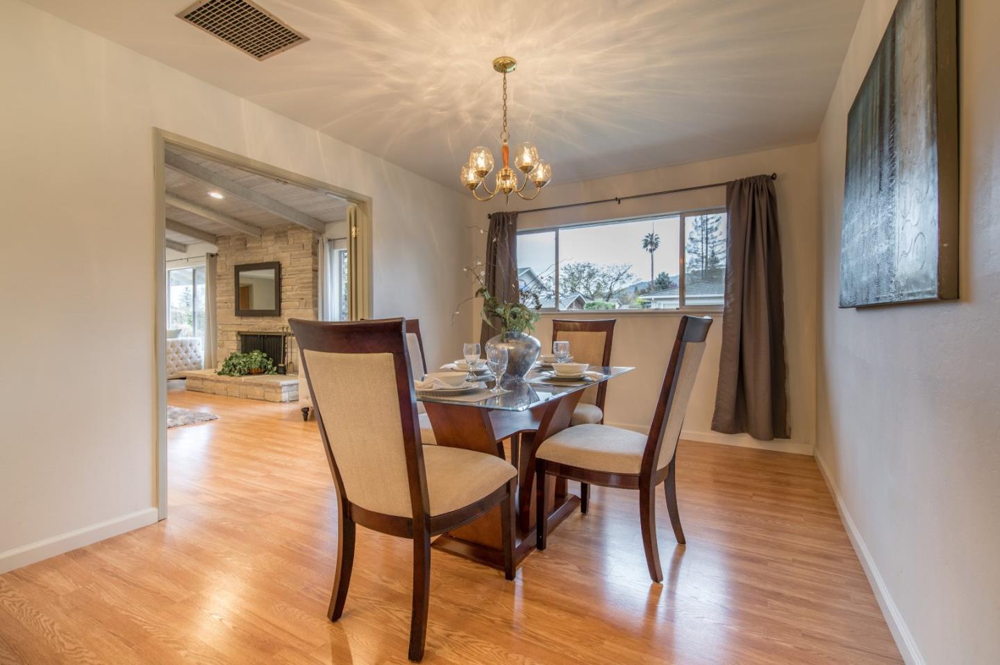 20249 Edinburgh Drive Saratoga, CA 95070 - Photo 9 of 32 a dining room with furniture a chandelier and wooden floor