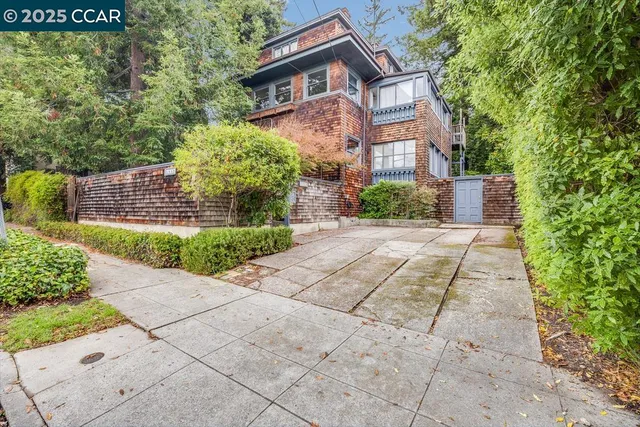 a front view of a house with a yard and a garden