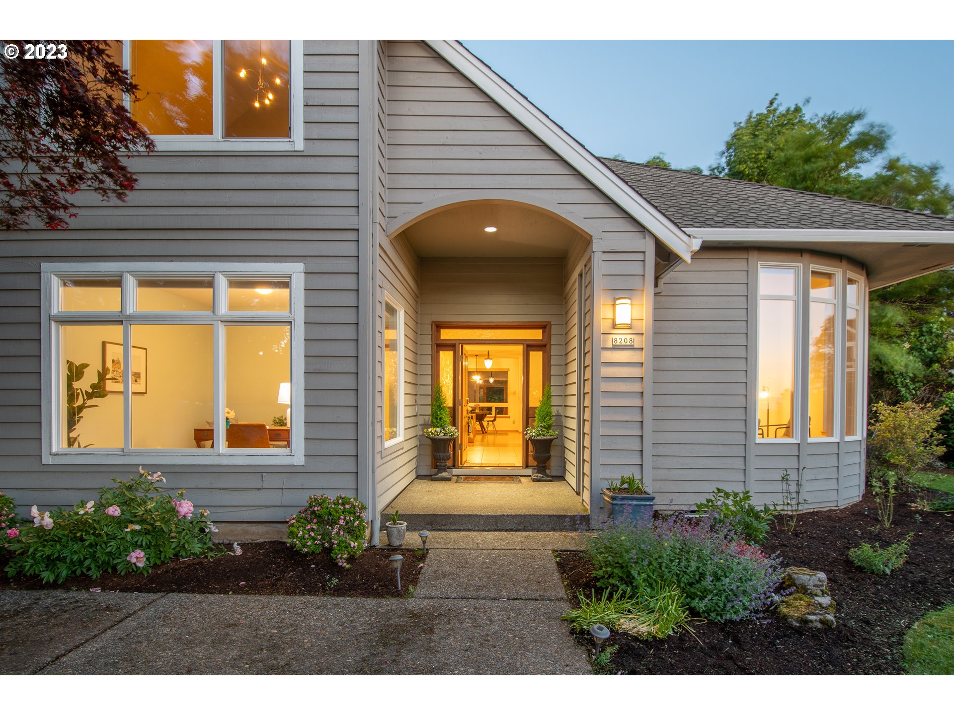 a view of a house with potted plants