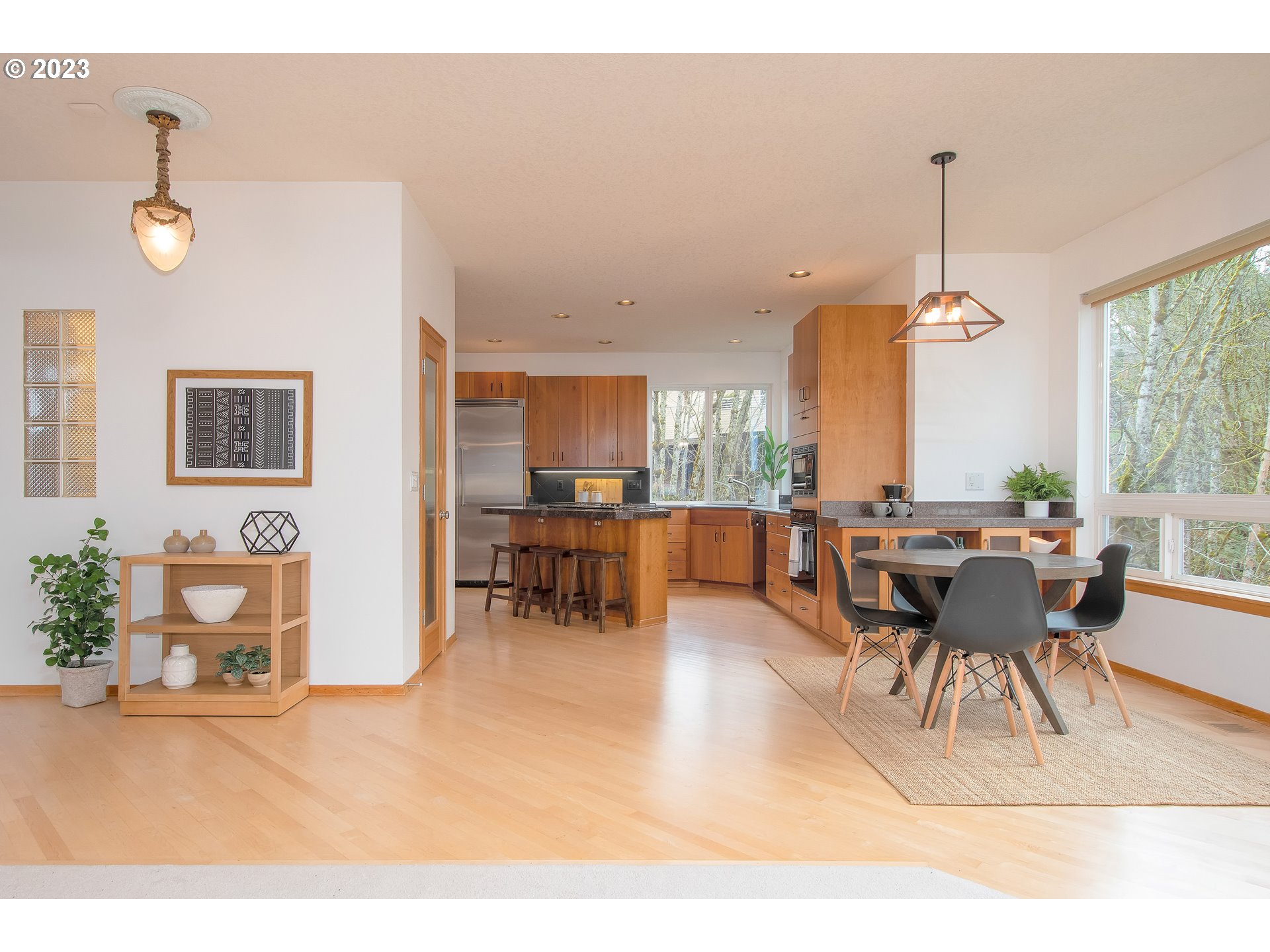 8208 Northwest Reed Drive Portland, OR 97229 - Photo 11 of 39 a living room with furniture a dining table and a large window