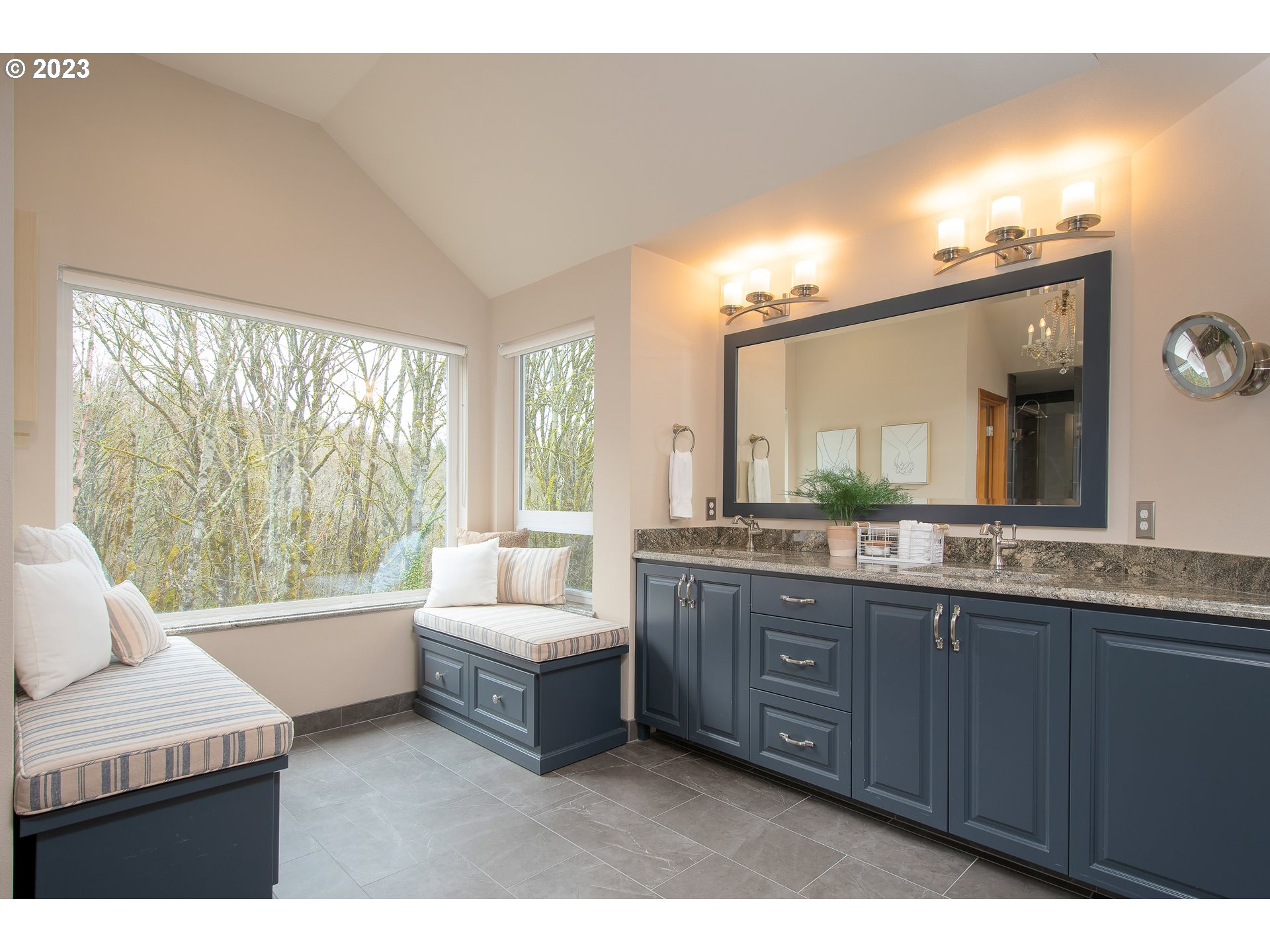 8208 Northwest Reed Drive Portland, OR 97229 - Photo 21 of 39 a bathroom with a double vanity sink large mirror and a bathtub