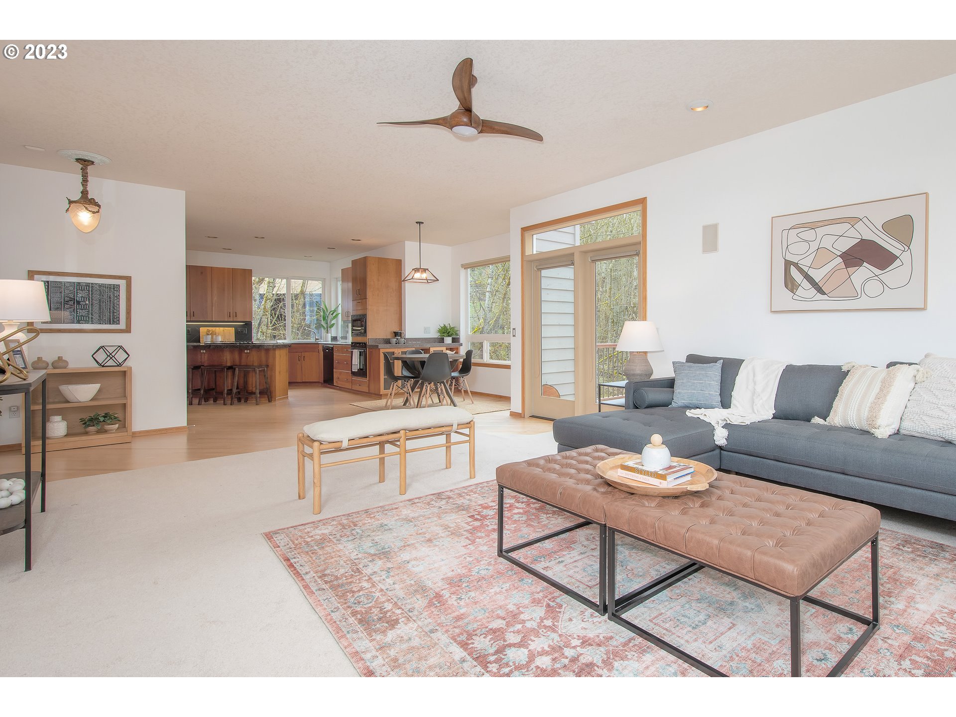 8208 Northwest Reed Drive Portland, OR 97229 - Photo 10 of 39 a living room with furniture and a kitchen view