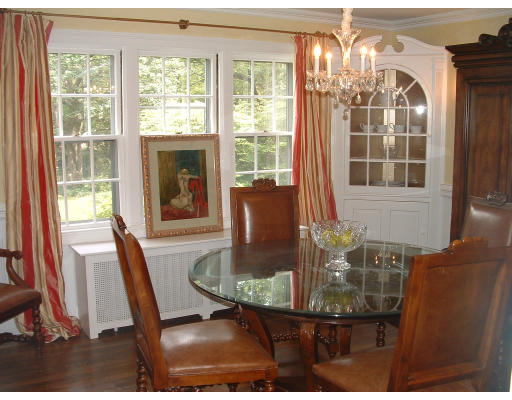 222 Boston Post Road Weston, MA 02493 - Photo 8 of 12 a view of a dining room with furniture wooden floor and chandelier