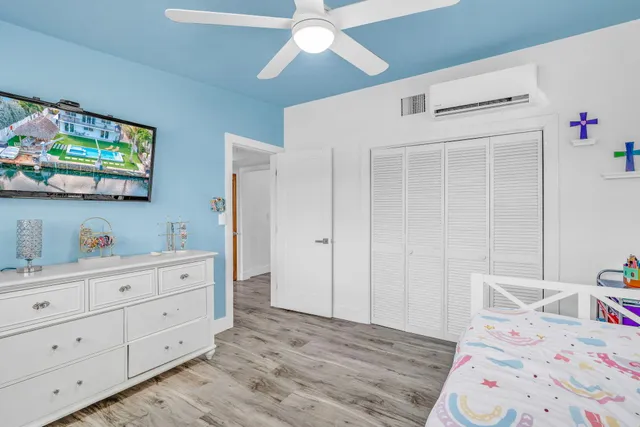 a bedroom with a bed and a dresser in it