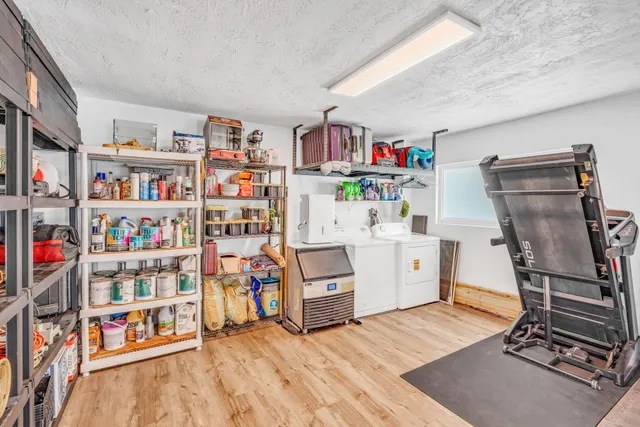 a room with furniture a rug and a book shelf