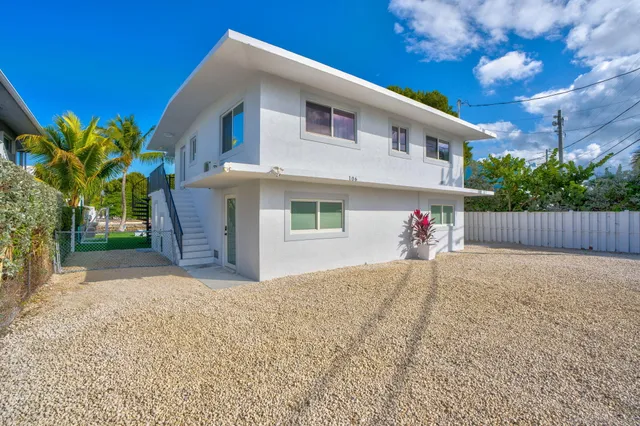 a front view of a house with a yard and a garage
