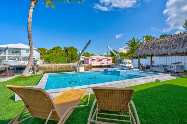 a view of a backyard with swimming pool