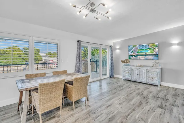 a view of a dining room with furniture and a chandelier