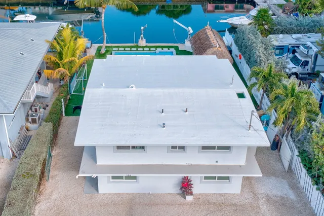 a view of a chairs and table in front of house