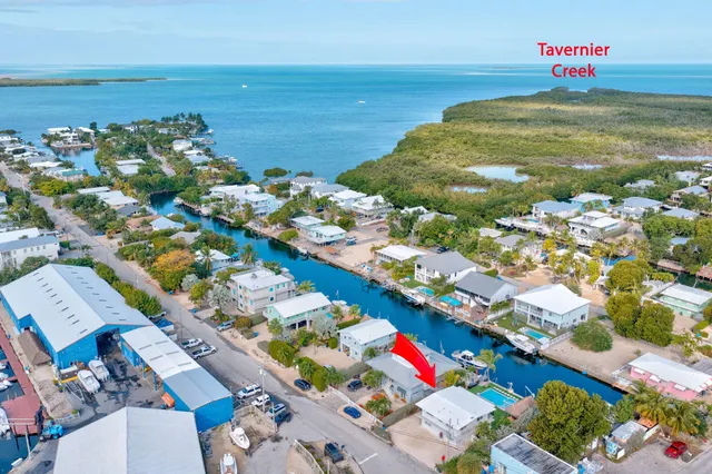 an aerial view of a house with garden space and outdoor seating