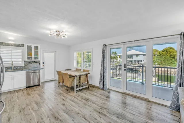 a view of a kitchen with a sink wooden floor and a kitchen