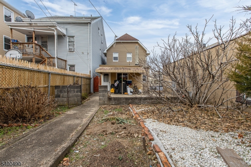 1029 East 19th Street Paterson, NJ 07501 - Photo 6 of 19 a view of a house with a yard