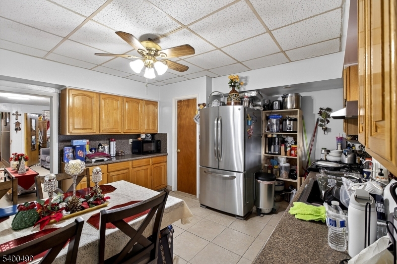 1029 East 19th Street Paterson, NJ 07501 - Photo 10 of 19 a kitchen with stainless steel appliances granite countertop a refrigerator and a stove top oven