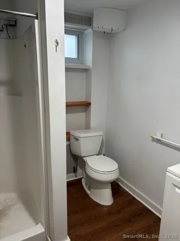 a bathroom with a toilet and a shower