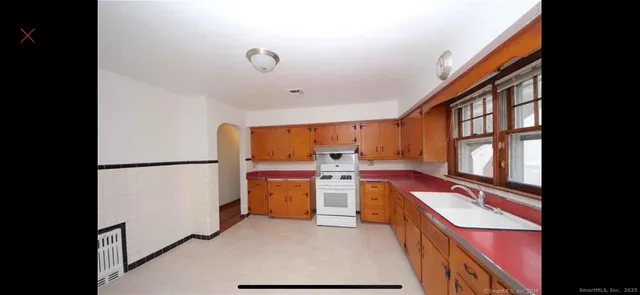 a kitchen with a refrigerator and a stove