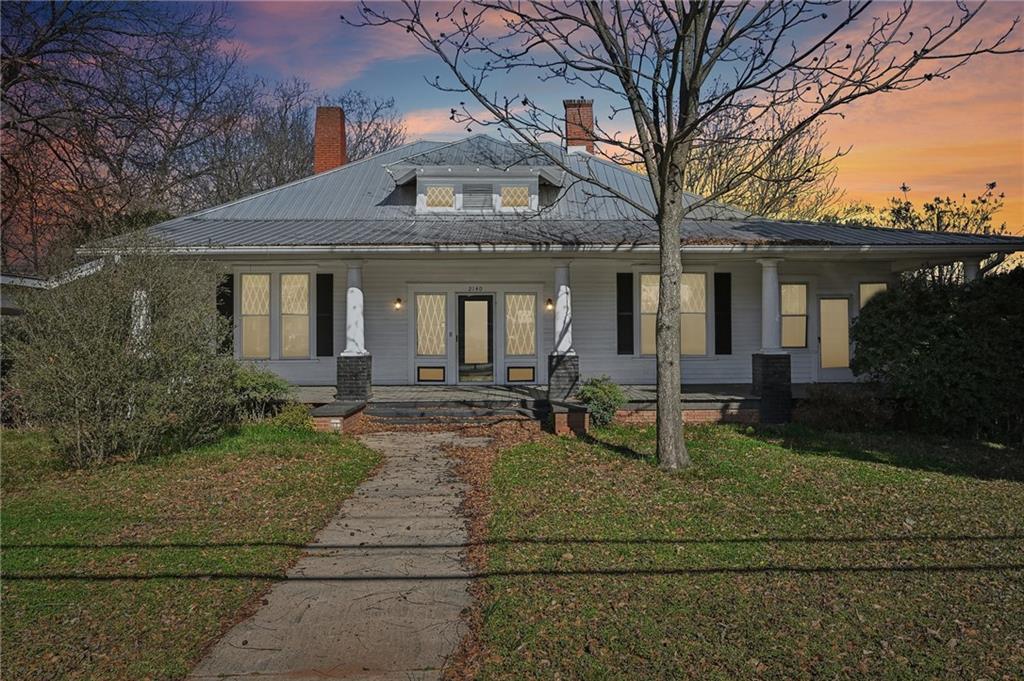 a front view of house with yard outdoor seating and green space