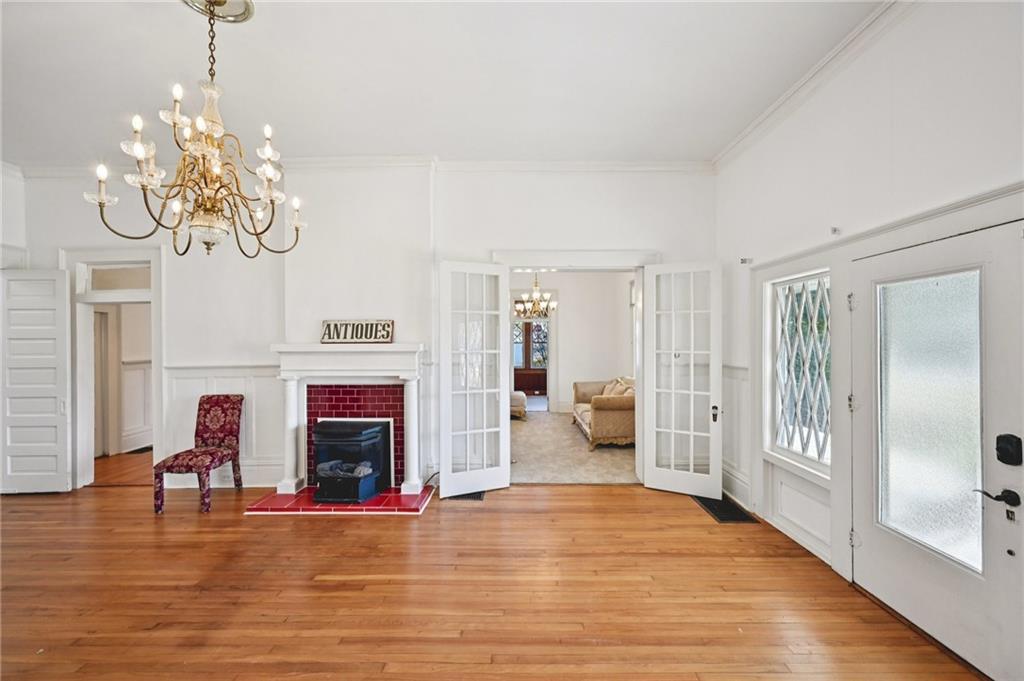 2140 North Broad Street Commerce, GA 30529 - Photo 12 of 33 a living room with fireplace furniture and a chandelier