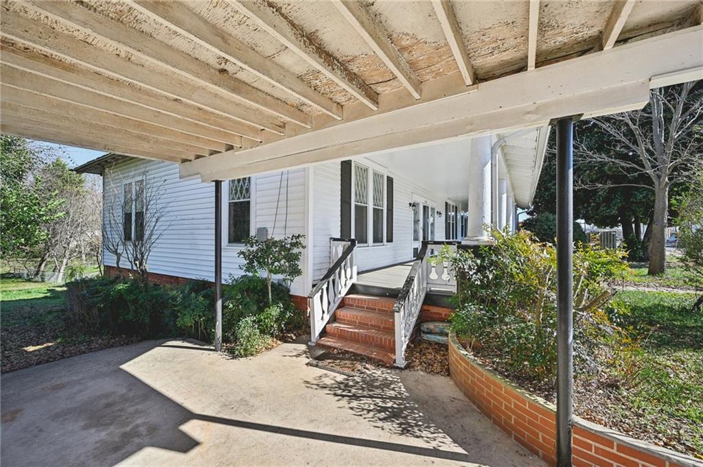 2140 North Broad Street Commerce, GA 30529 - Photo 7 of 33 a view of a porch with plants and wooden fence