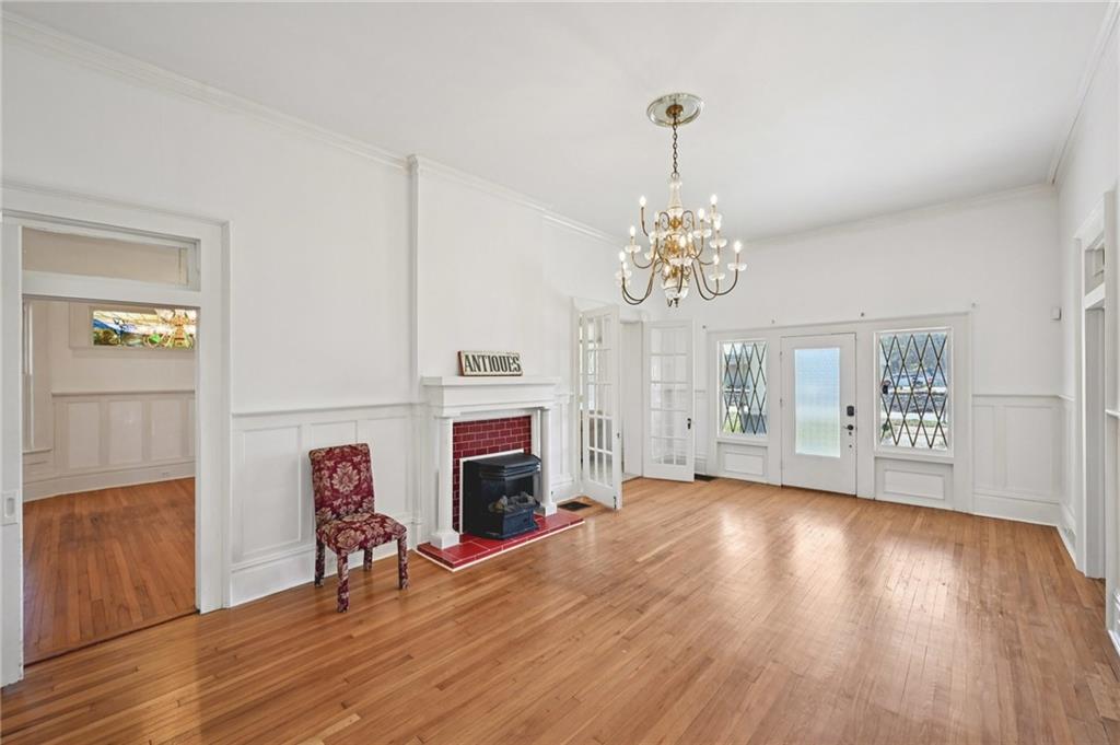 2140 North Broad Street Commerce, GA 30529 - Photo 8 of 33 a living room with furniture a chandelier and a fireplace