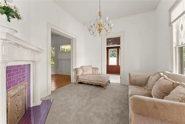 a living room with furniture and a chandelier