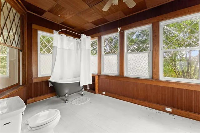 a bathroom with a sink toilet bathtub and next to a window