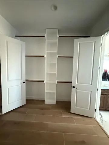 a view of walk in closet with empty shelves