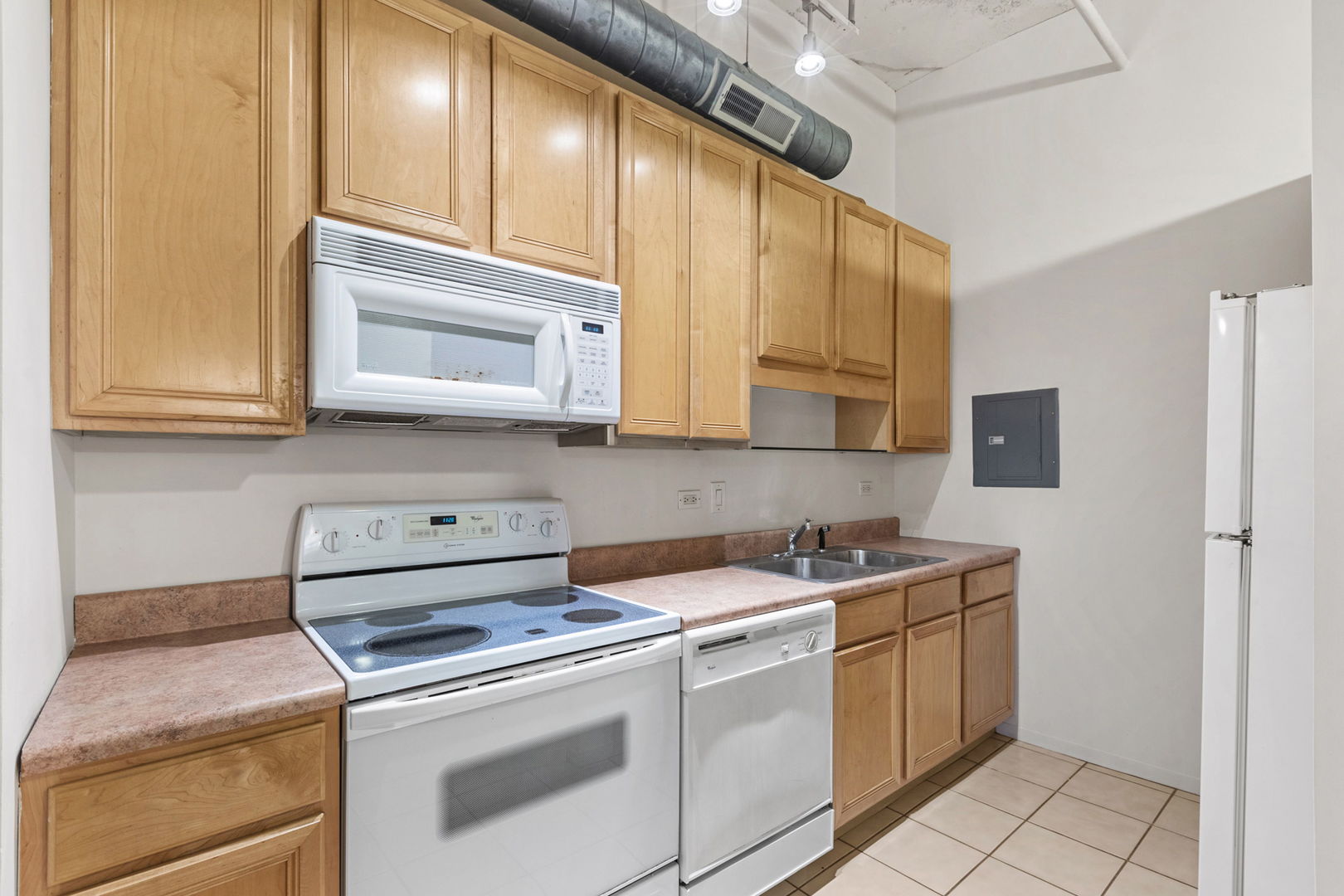 801 South Wells Street, Unit 808 Chicago, IL 60607 - Photo 11 of 15 a kitchen with stainless steel appliances granite countertop a sink stove and microwave